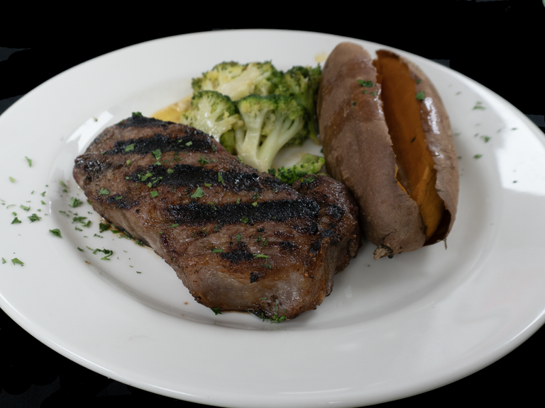 A char-grilled steak with broccoli and a baked sweet potato at Char Restaurant in St. Albans. Photo: Char Restaurant