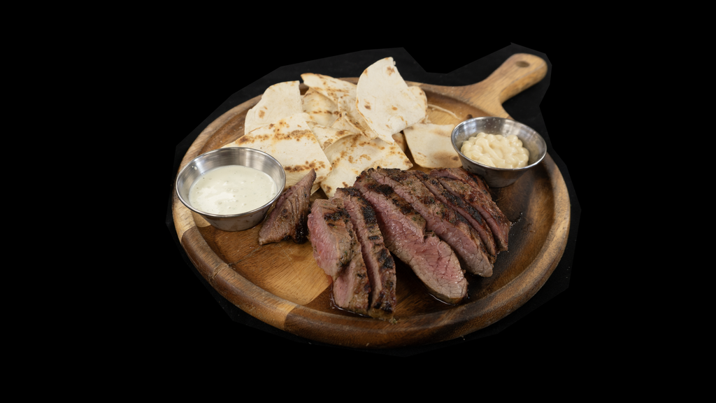 The Carne Asada Board at Char Restaurant, with sliced skirt steak, flatbread, and sauces. Photo: Char Restaurant