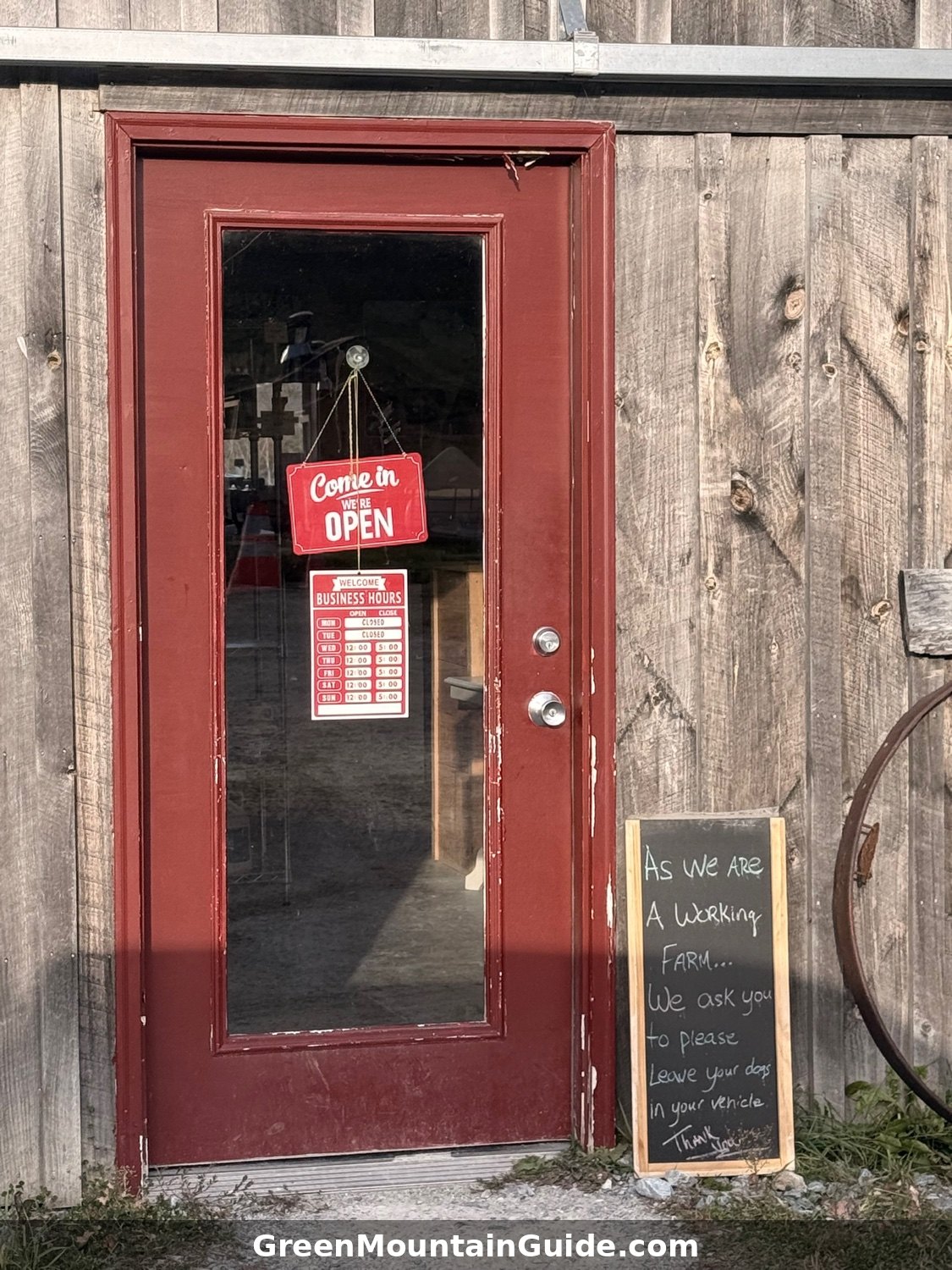 The farm stand door at Plew Farm, with its hours posted