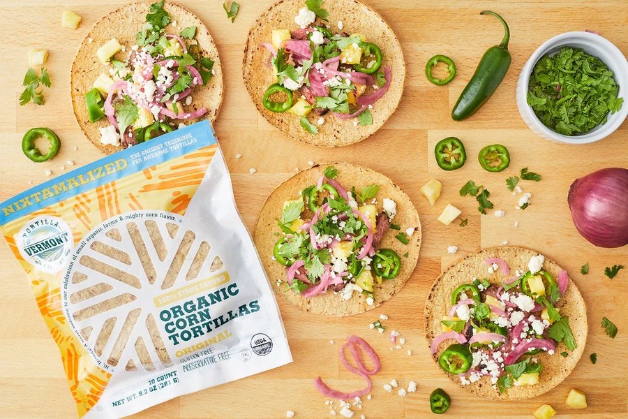 Open tacos with fresh toppings beside a pack of Vermont Tortilla Company Original tortillas. Photo: Vermont Tortilla Company