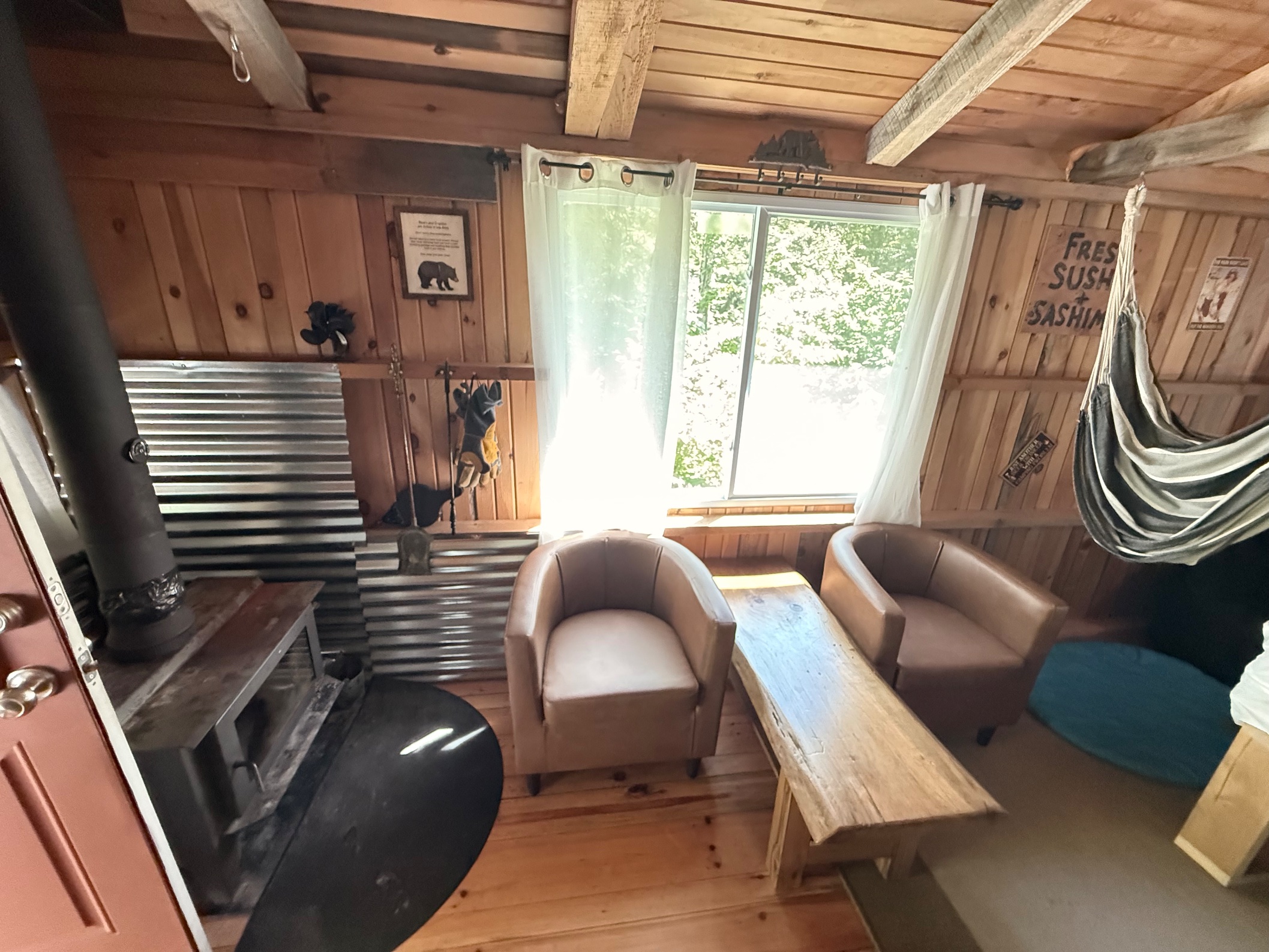 Inside the camp - wood stove, cozy chairs, and everything running on solar